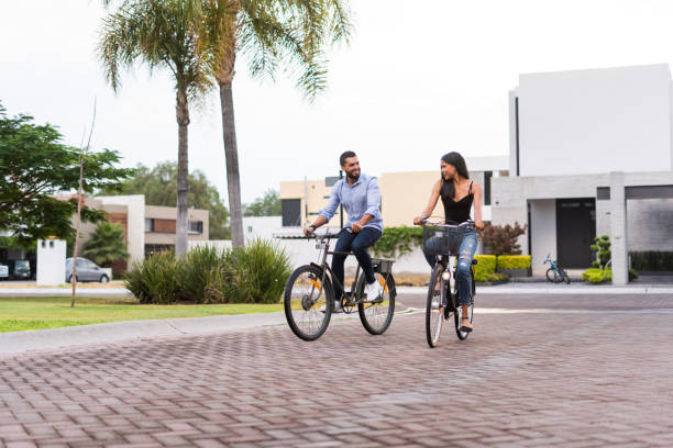 istock Latino couple riding bikes together 1160811105