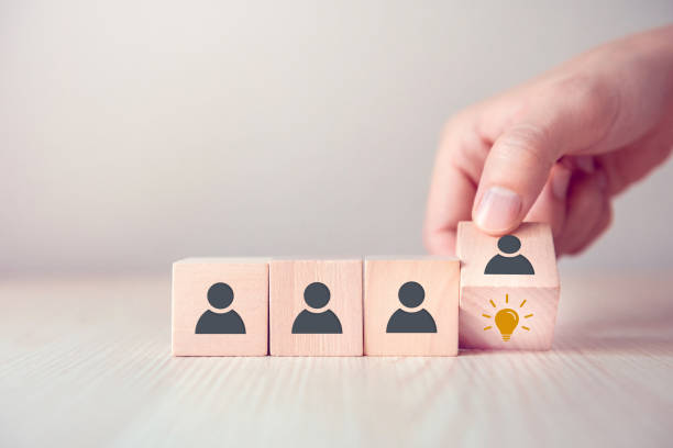 istock Leader with idea and innovation, Woman hand flips cube with icon light bulb and human symbol. 1160812432