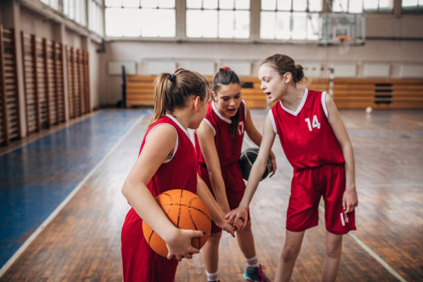 istock Female School Basketball Team Huddling 1160813170