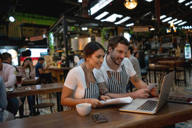 istock Waiters working at a restaurant managing the finances 1160815687