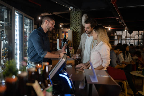 istock Couple at a wine at a cellar talking to the sommelier 1160816265
