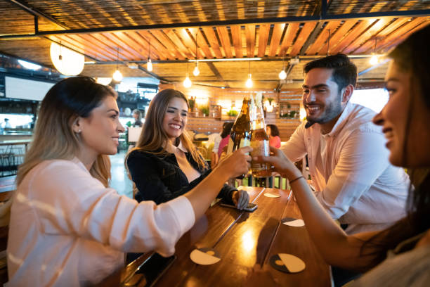 istock Friends at the bar making a toast while having drinks 1160816276