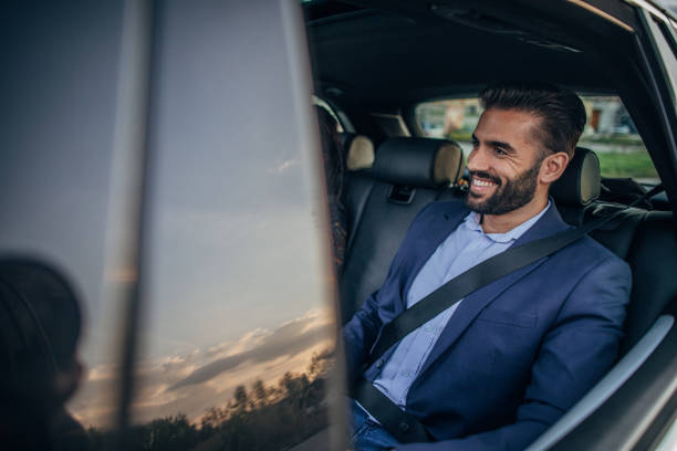 Rear View Of A Young Businessman Driving Car