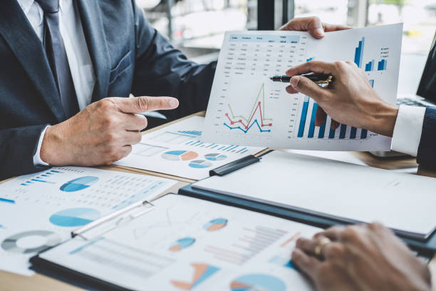 istock Two executive discussing company growth project success financial statistics, Partner meeting professional investor working start up project for both company with document, laptop and digital tablet 1160817528