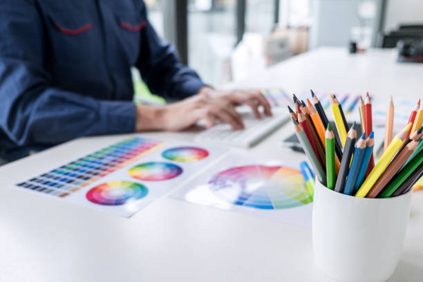 istock Image of male creative graphic designer working on color selection and drawing on graphics tablet at workplace with work tools and accessories 1160817612