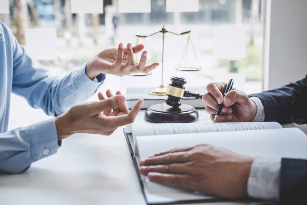 Consultation and conference of Male lawyers and professional businesswoman working and discussion having at law firm in office. Concepts of law, Judge gavel with scales of justice stock photo