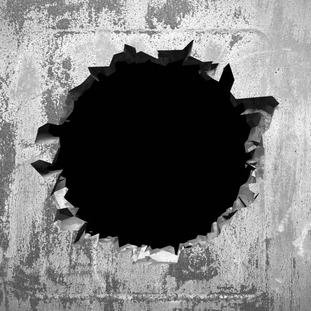 Dark cracked broken hole in concrete wall. Grunge background stock photo