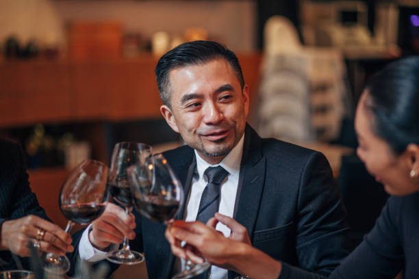 istock Business people sitting in restaurant and drinking wine 1160819633