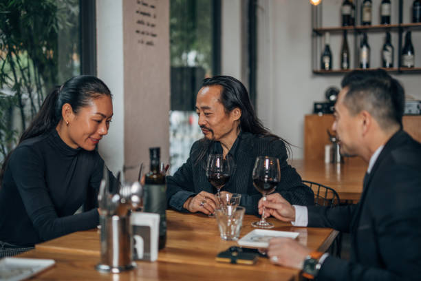 istock Business people sitting in restaurant and drinking wine 1160819761