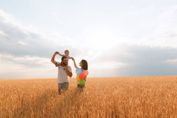 istock Happy family: mother, father and son on nature 1160819946