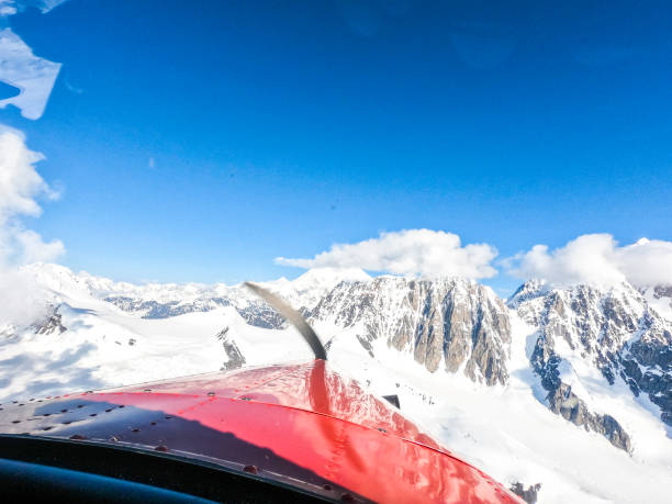 Denali National Park, Healy, Alaska, USA - June 13 2019: Flying inside of Denali National Park. Photo is taken inside a propeller plane. Denali is the tallest mountain in North America.