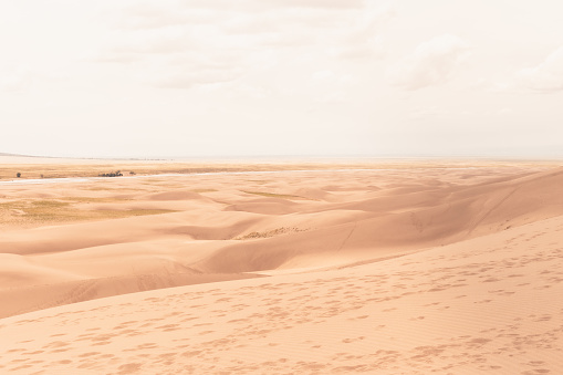 Car on sand dunes in the desert, Merzouga, Erg Chebbi sand dunes region, Sahara, Morocco.