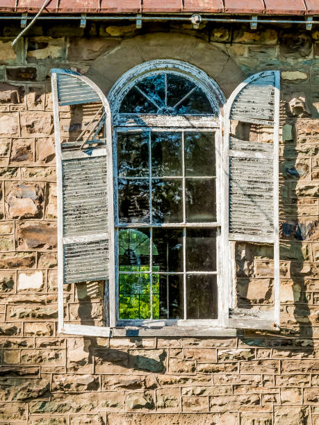istock Abandoned And Broken Church Window And Shutters 1160824034