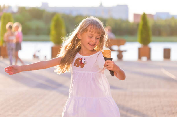 istock Girl, ice cream, white dress, fun 1160824739