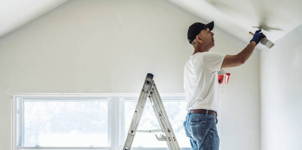 istock Senior man painting apartment interior 1160824858
