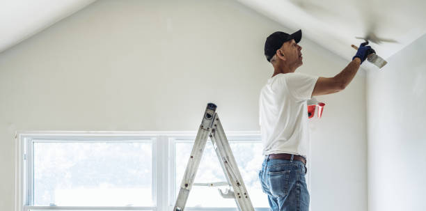 Senior man painting apartment interior Retirement life. Time to downsize your home. Senior man painting apartment interior. house painter ladder paint men stock pictures, royalty-free photos & images