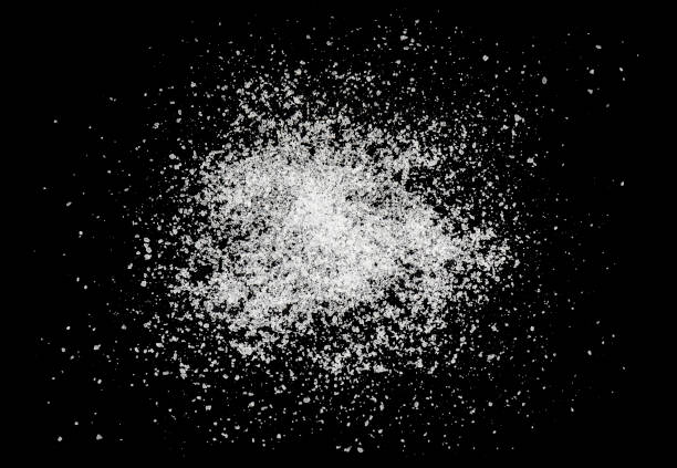 istock Crystals of salt isolated on black background 1160825337