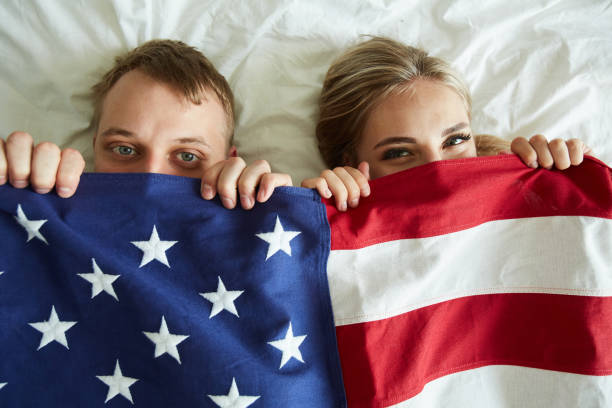 istock Young couple covering by American flag 1160825402