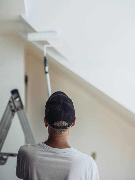istock Senior man painting apartment interior 1160826628