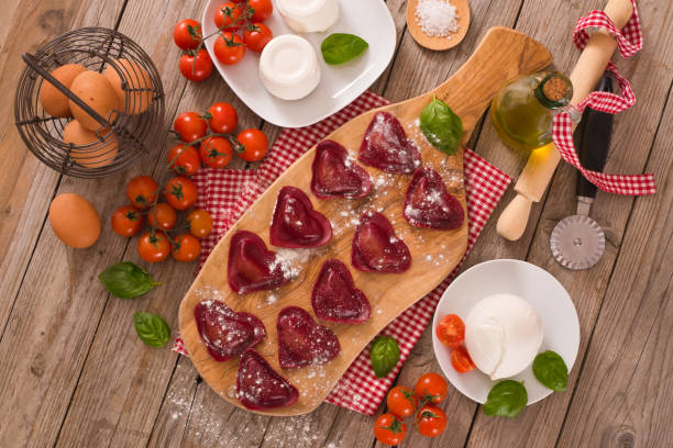 istock Red heart ravioli with tomato, mozzarella and basil. 1160828107