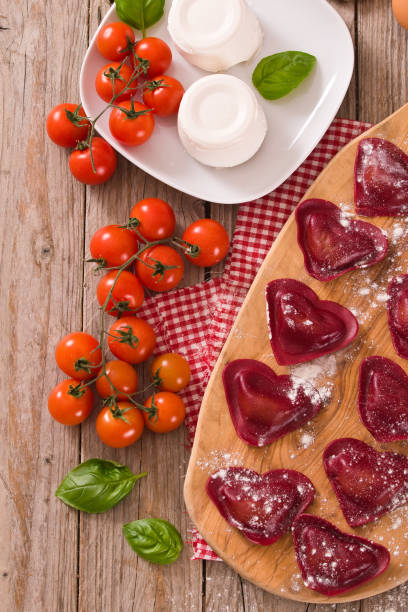 istock Red heart ravioli with tomato, mozzarella and basil. 1160828192