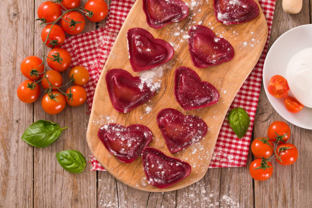 istock Red heart ravioli with tomato, mozzarella and basil. 1160828199