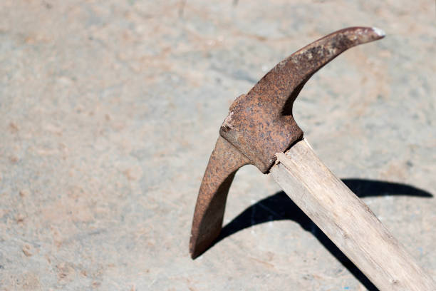The pickaxe tool lies striking a stone. Extraction of stone iron pick with a handle.