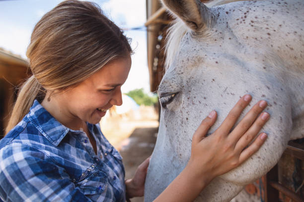 istock Cheerful girl embracing her mare horse 1160828521