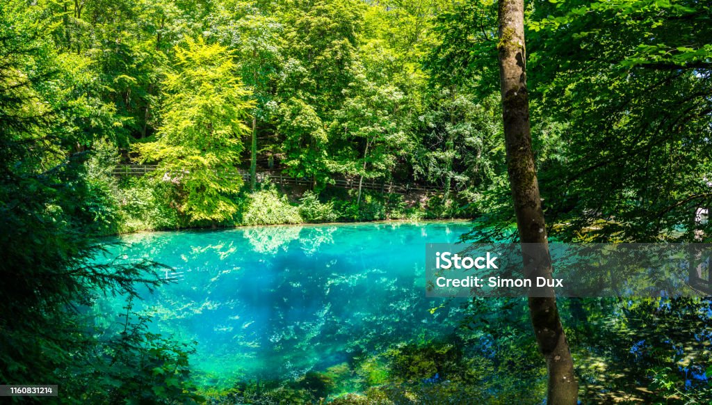 Germany, XXL nature landscape panorama of blue waters of natural spring, called blautopf (blue pot) in blaubeuren in swabian jura, a popular tourist destination Germany Stock Photo