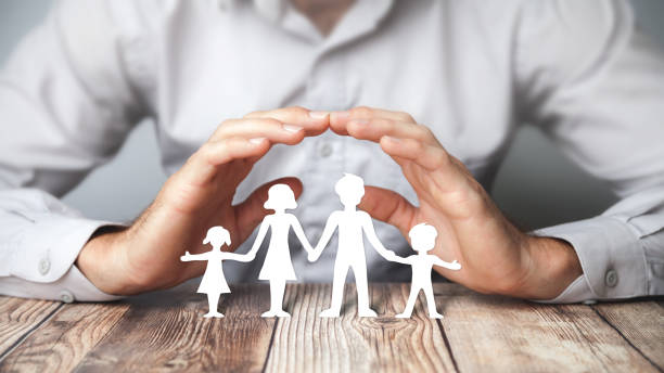 istock Protecting Hands Over Paper Family 1160832123