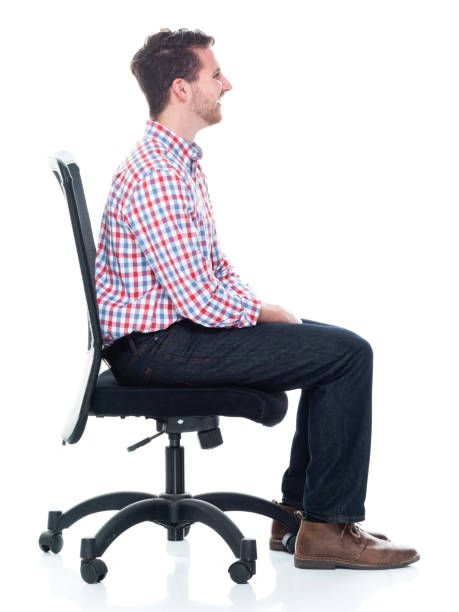 istock Attractive young man wearing a checked shirt and jeans - sitting 1160832226