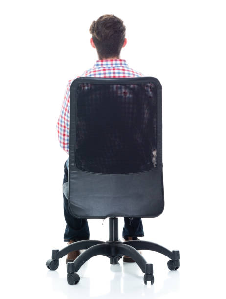istock Attractive young man wearing a checked shirt and jeans - sitting 1160832230