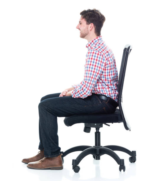 istock Attractive young man wearing a checked shirt and jeans - sitting 1160832231