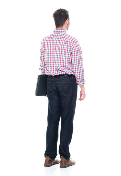 istock Attractive young man wearing a checked shirt and jeans - using a laptop 1160832300