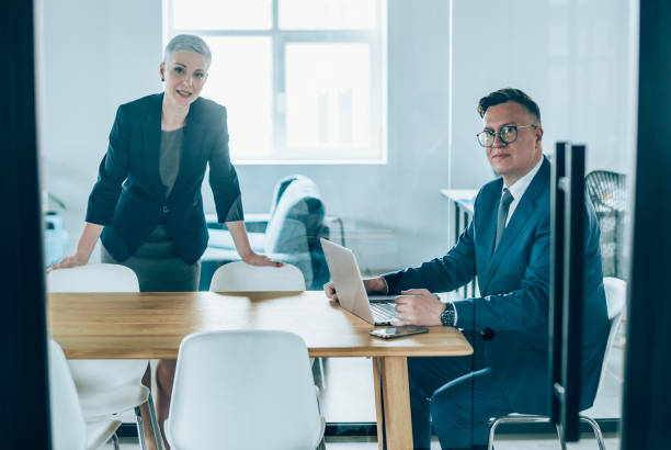 istock Business persons talking in conference room 1160835704