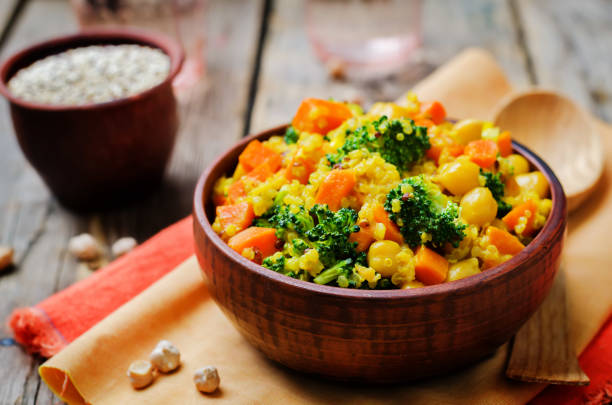 Quinoa broccoli carrot curry on a wood background