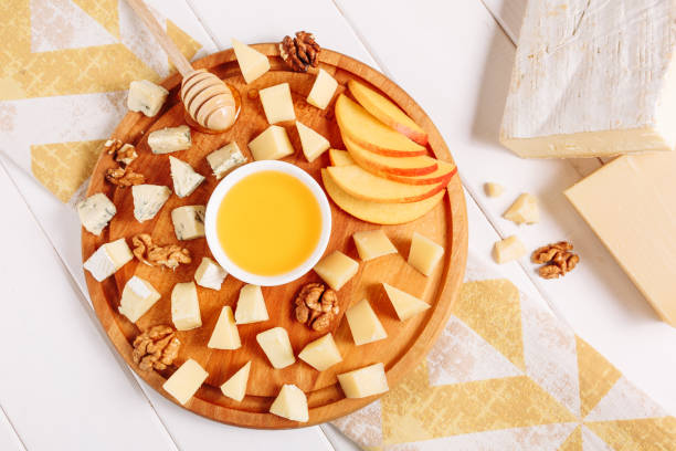 Italian Cheese Board Peach Gourmet Food Flat Lay Italian Cheese Board Peach Gourmet Food Flat Lay. French Cheeseboard with Brie, Parmesan and Mozzarella Assorted Top Down View. Various Blue Cheddar, Gouda and Walnut Appetizer Dessert Platter Above pear dessert stock pictures, royalty-free photos & images