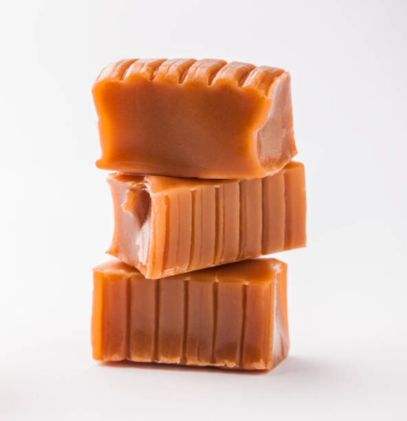 istock Caramels candy cubes arrangement stacked close-up front view vibrant isolated 1160843479