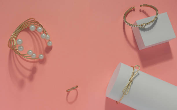 istock Golden and pearl bracelets set on pink background top view 1160844580