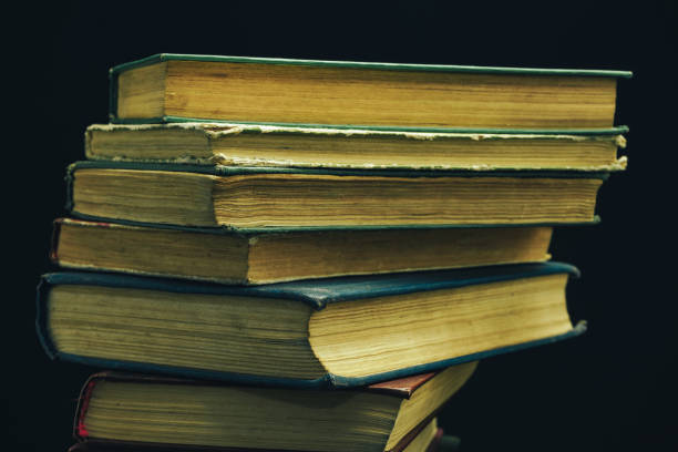 istock Close up Old books on a  table black background. 1160845925