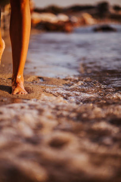 istock Woman walking on the beach 1160846658