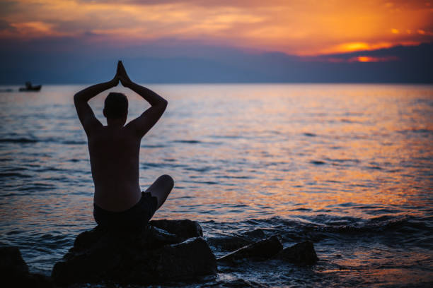 istock Yoga on the beach during idyllic sunset 1160846673