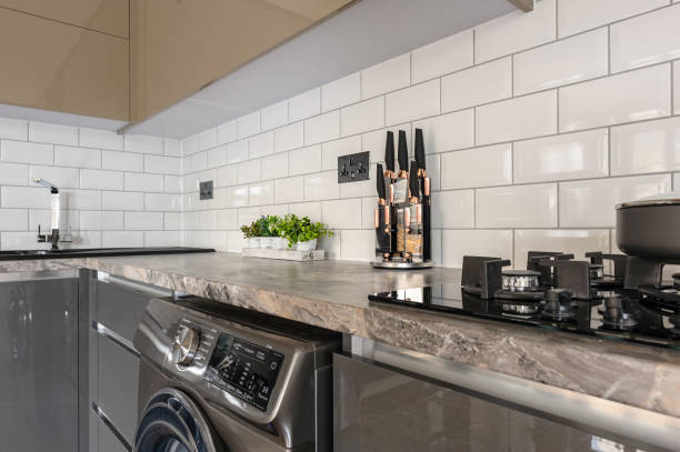 istock Closeup of luxury modern white, beige and grey kitchen interior 1160847065