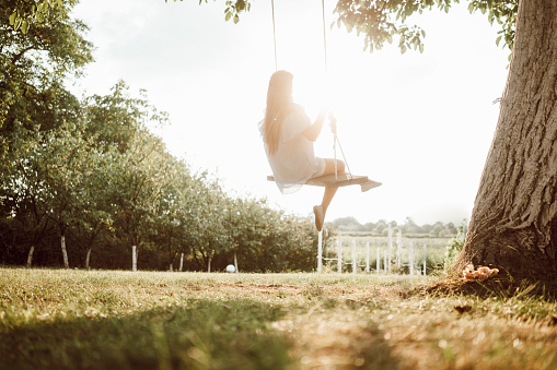 Beautiful woman enjoying on a swing