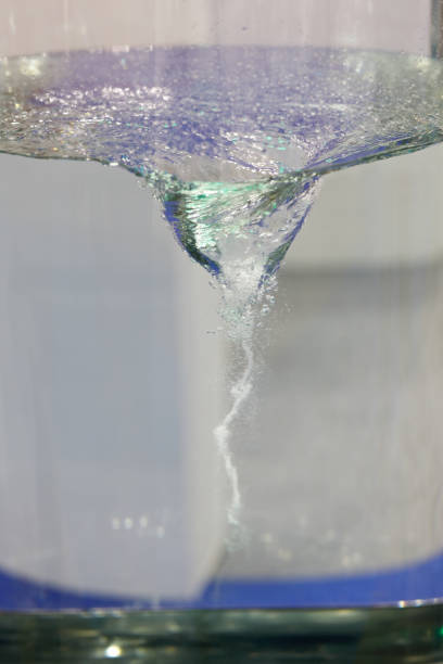 Clear colorless liquid mixing in a magnetic stirrer. Water vortex.