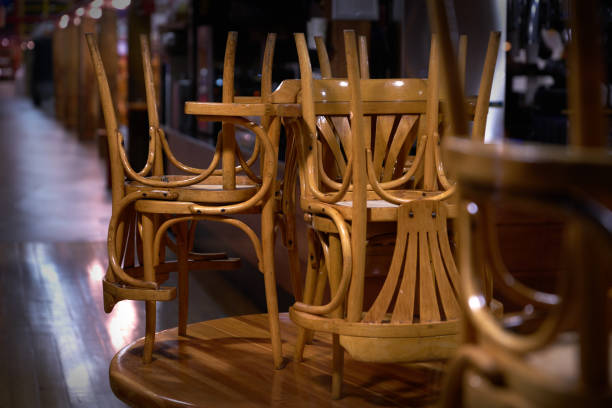 After Hours Closing A view of a closed restaurant after hours. restaurants tables and chairs stock pictures, royalty-free photos & images
