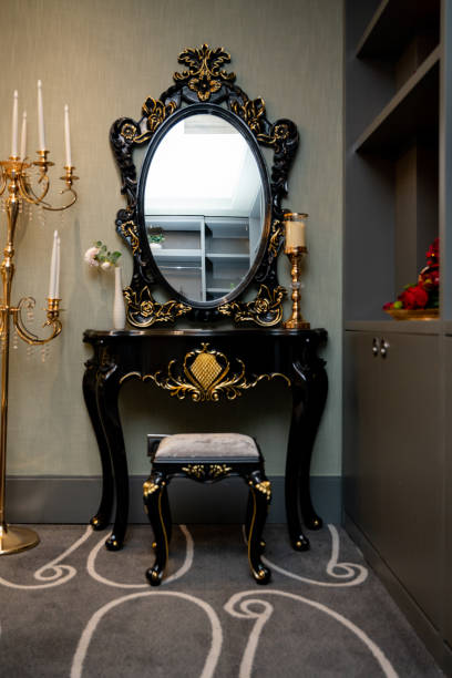 istock A mirror in a black frame on a table with legs, standing in a corner in the room. 1160853457