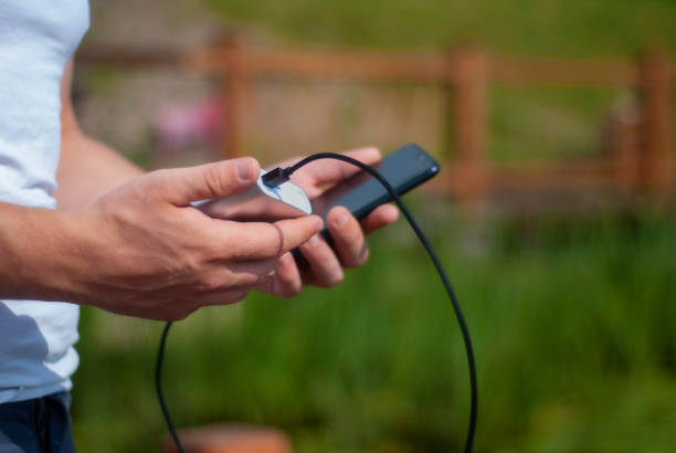 istock Men holds a portable charger with a smartphone in his hand. 1160856828