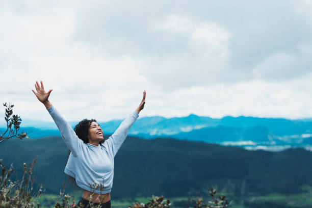 istock Woman in nature with open arms 1160859112