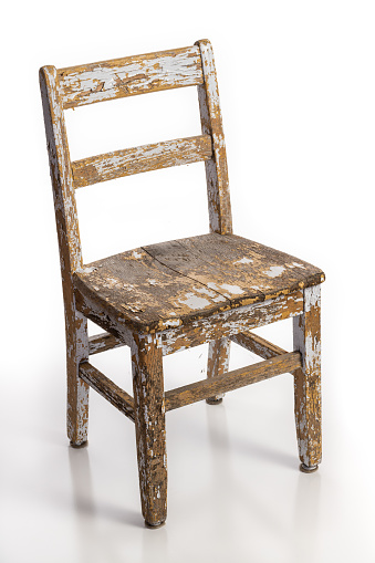 Old wooden chair with texture of flaking cracked paint peeling off isolated on a white background. Lead contamination concept.